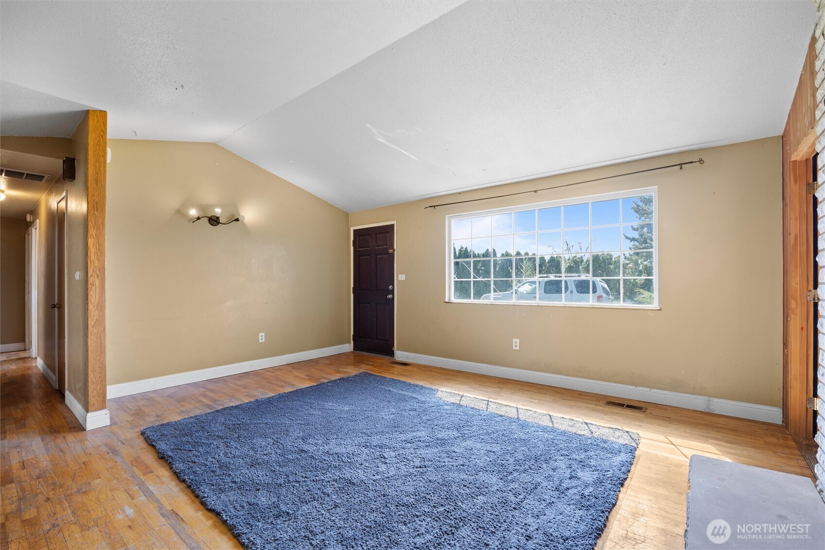 705 North 12th Street Selah, WA 98942 - Photo 6 of 32 a view of an empty room with wooden floor and a window