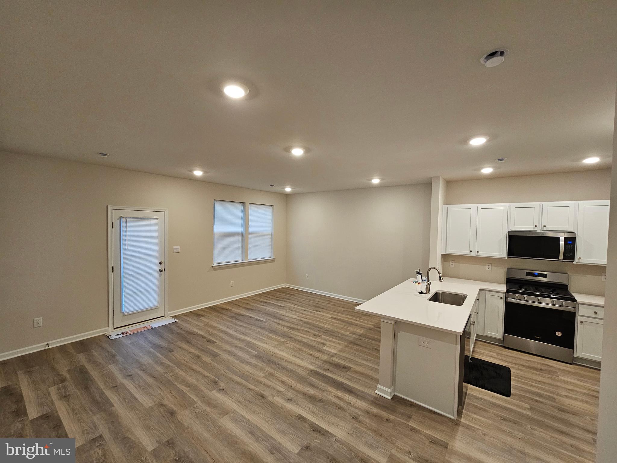 21 Alexander Way Westampton, NJ 08060 - Photo 11 of 25 a open kitchen with kitchen island a sink dishwasher stove with microwave and cabinets