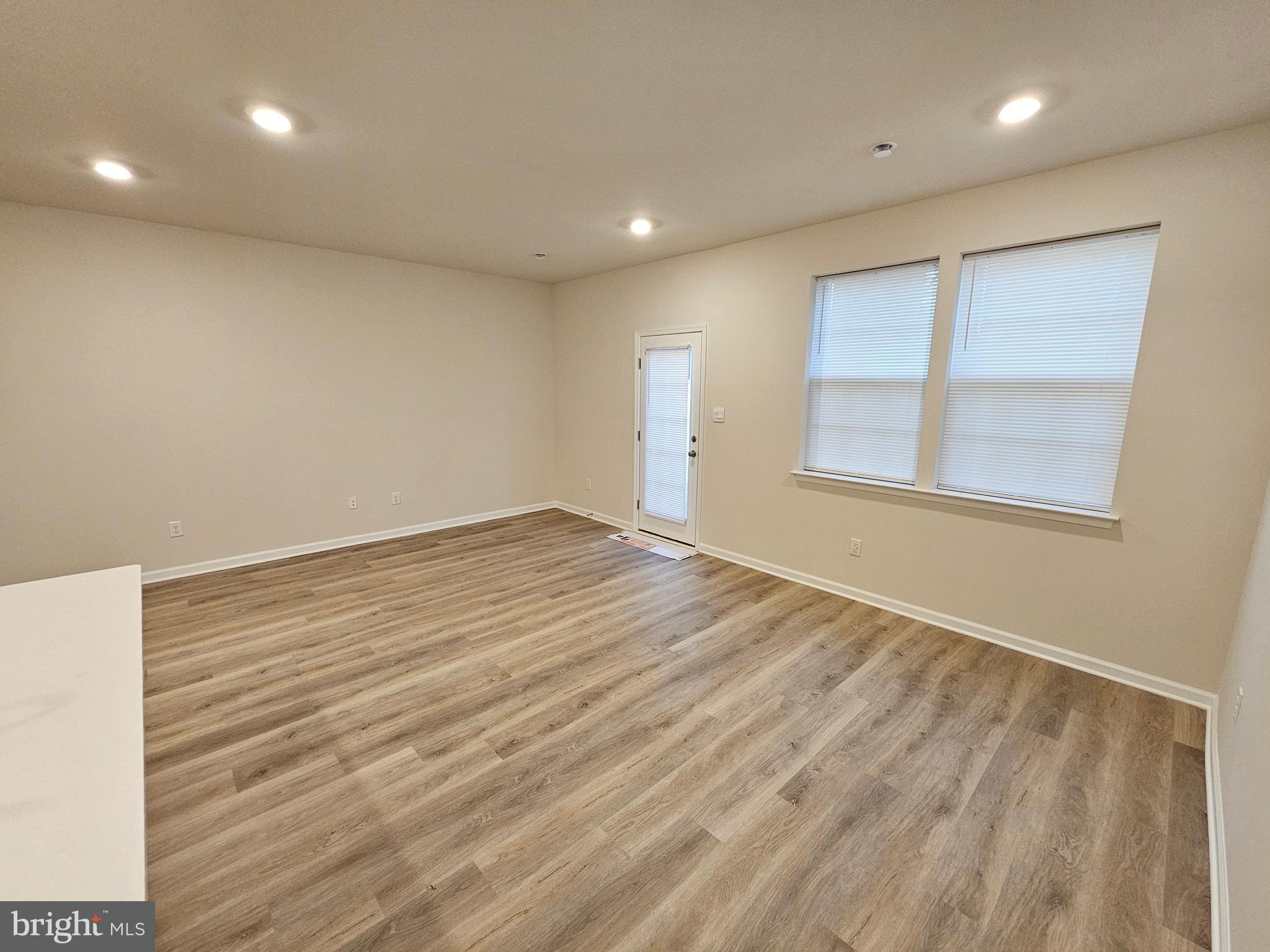 21 Alexander Way Westampton, NJ 08060 - Photo 5 of 25 an empty room with wooden floor and windows