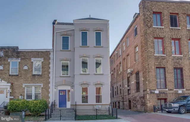 a front view of a building with a lot of windows