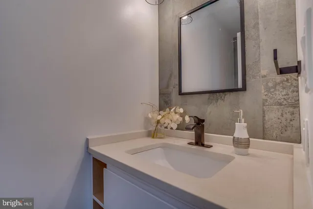 a bed room with a bed and painting on the wall