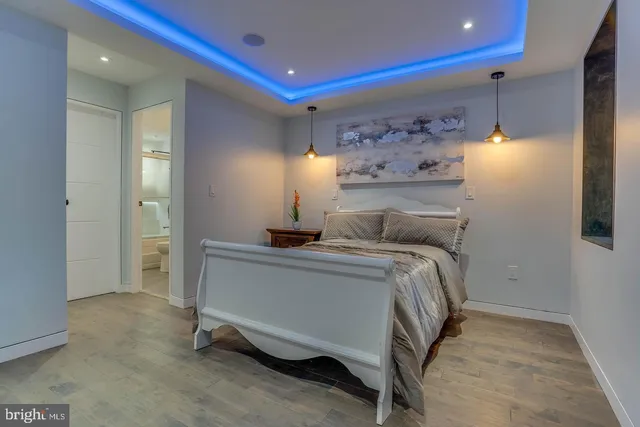 a bedroom with a bed and a potted plant