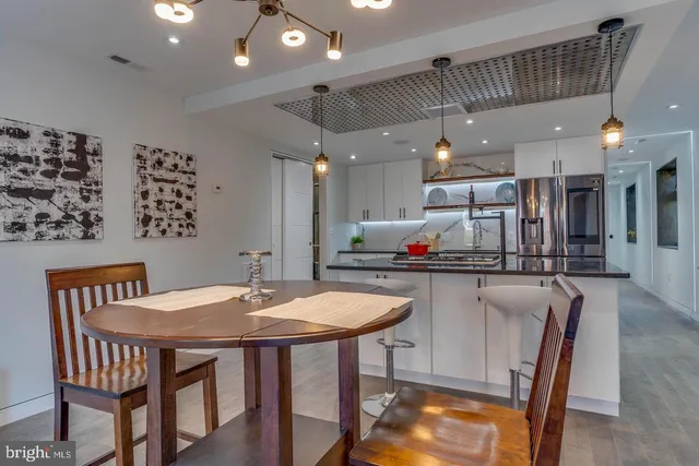 a kitchen that has a table and chairs in it