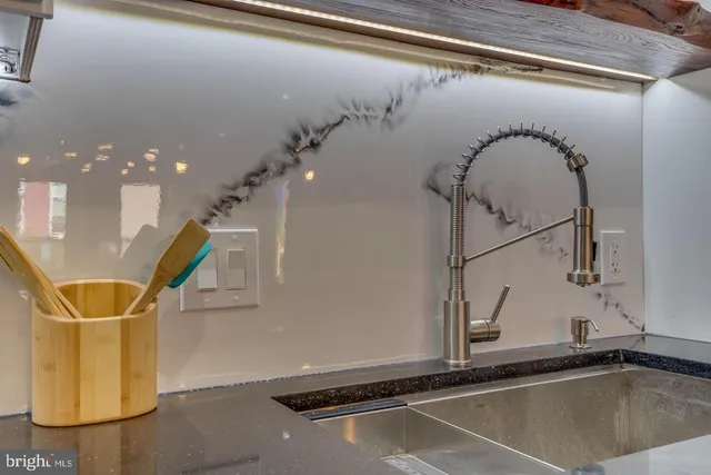 a kitchen with kitchen island a sink and a stove