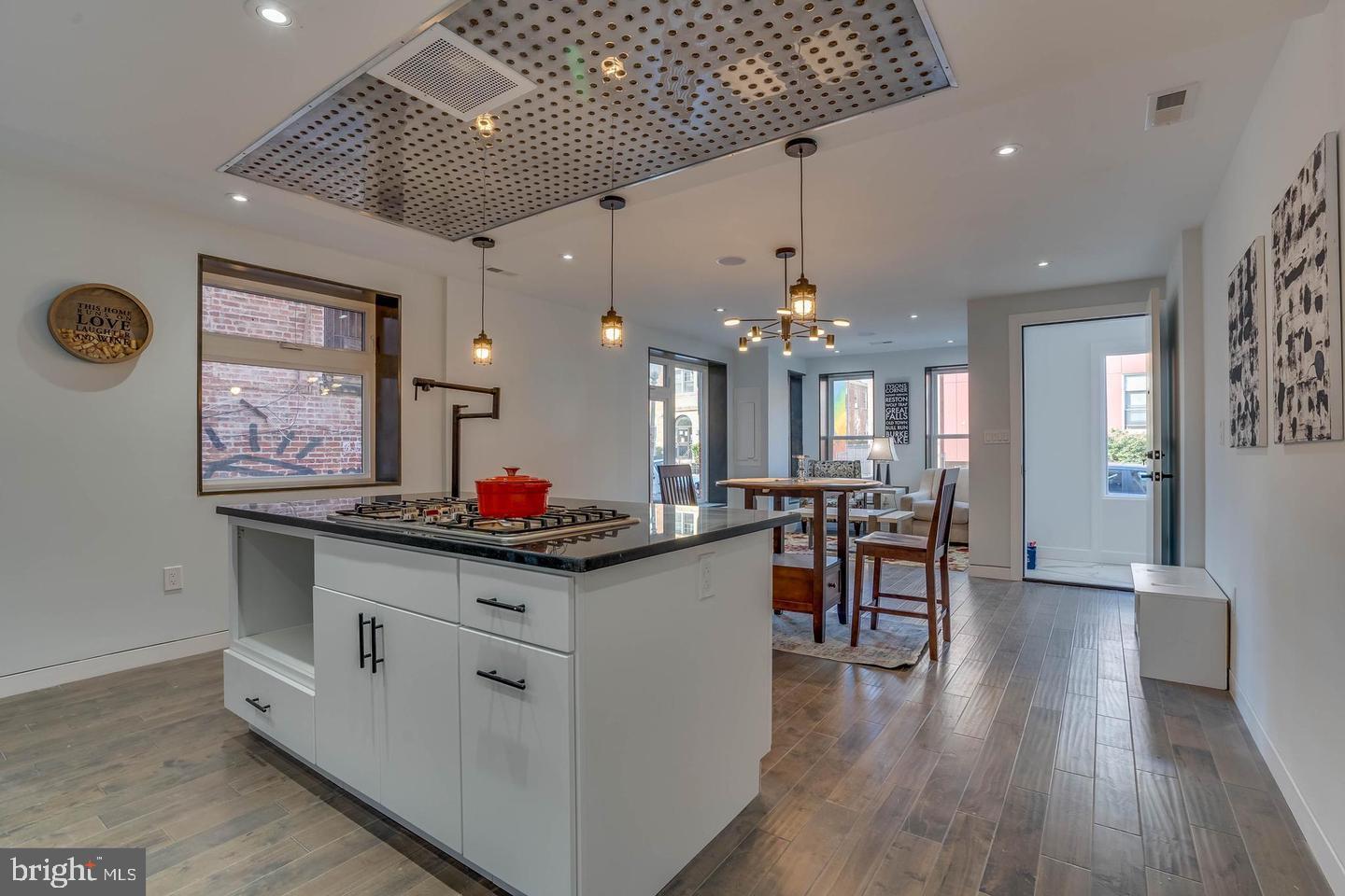 50 O Street Northwest Washington, DC 20001 - Photo 10 of 21 a kitchen that has a lot of cabinets a sink and wooden floor