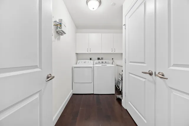 a utility room with cabinets washer and dryer