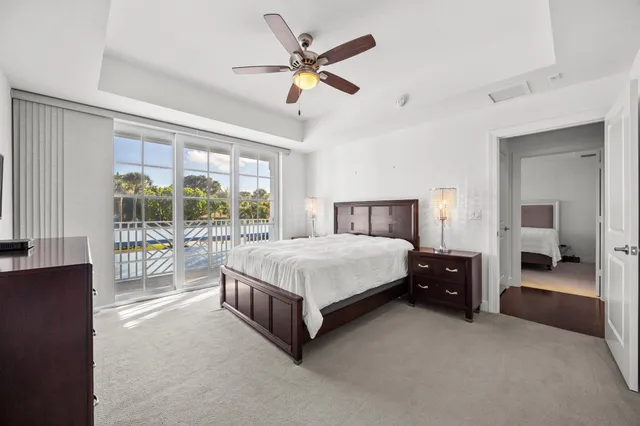 a spacious bedroom with a bed and a large window