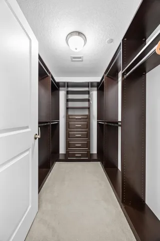 a view of hallway with stairs and a closet