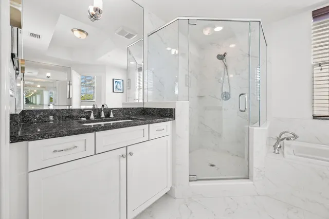 a bathroom with a shower sink and mirror