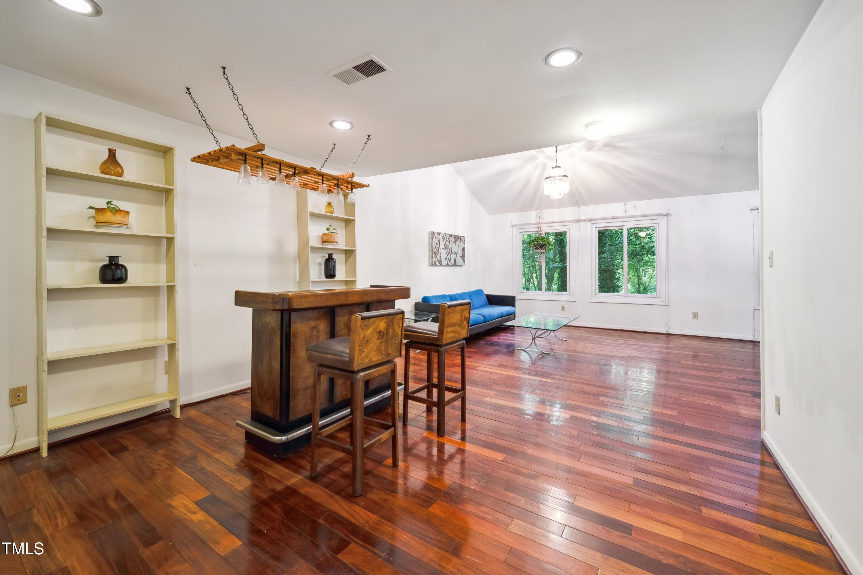 3416 Ocotea Street Raleigh, NC 27607 - Photo 14 of 46 a view of a dining room with furniture window and wooden floor