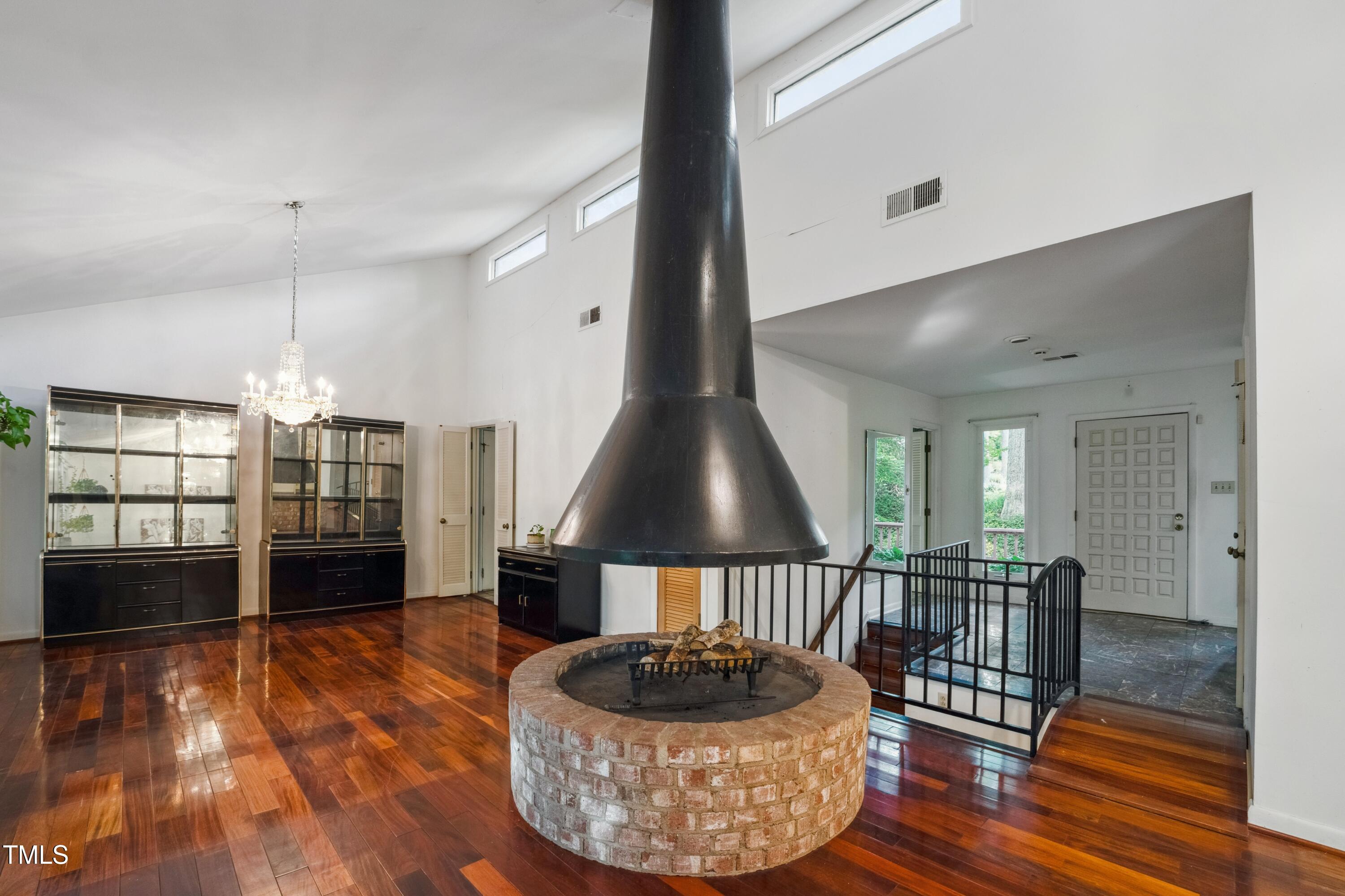 3416 Ocotea Street Raleigh, NC 27607 - Photo 17 of 46 a living room with furniture and a chandelier