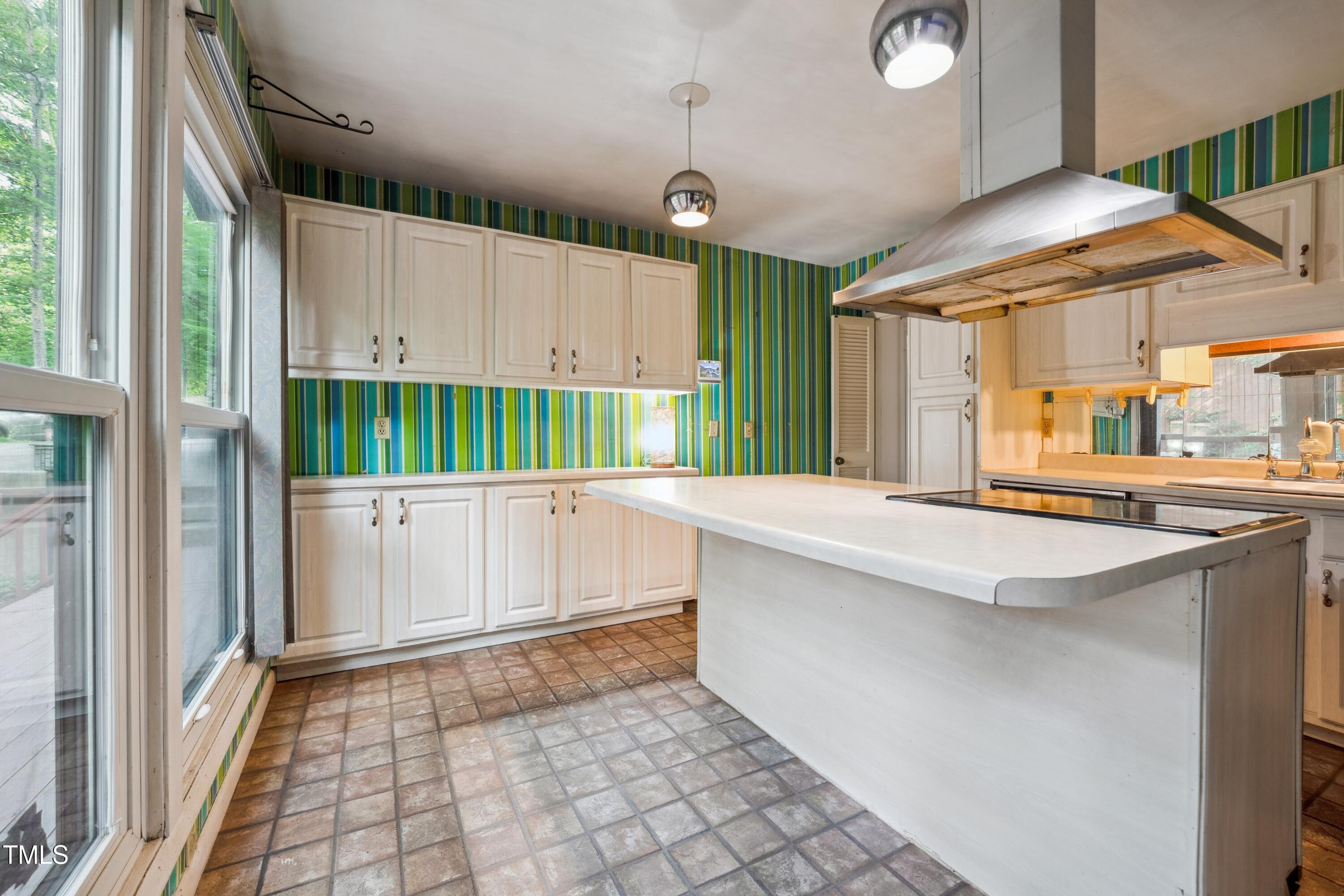 3416 Ocotea Street Raleigh, NC 27607 - Photo 20 of 46 a kitchen with a sink a counter top space and cabinets