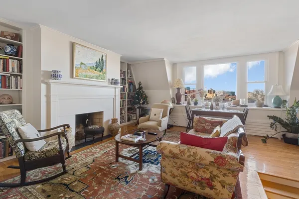 a living room with furniture a fireplace and a table