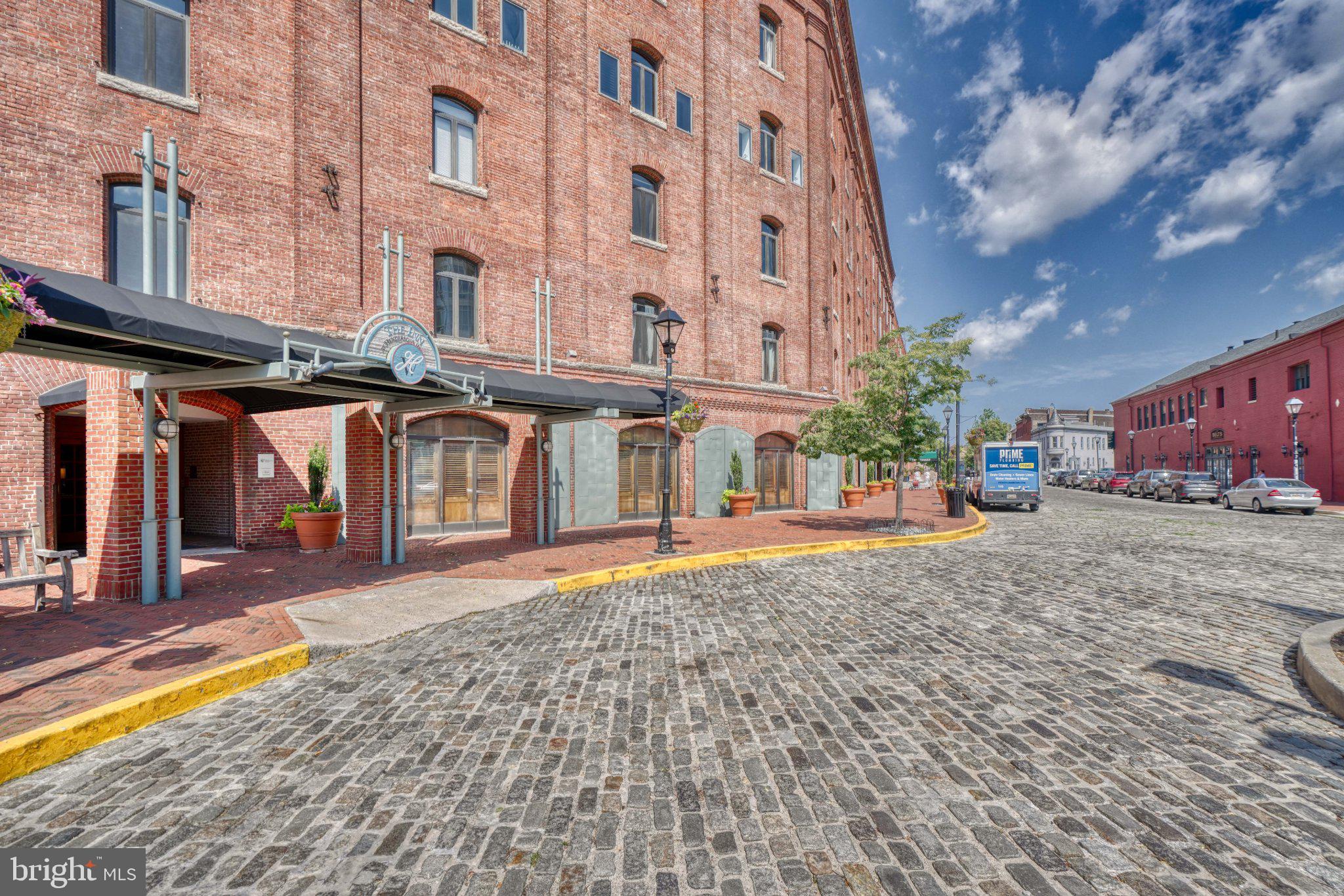 1000 Fell Street, Unit 606 Baltimore, MD 21231 - Photo 45 of 56 Historic brick building by cobblestone street.