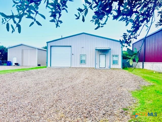 a view of a house with a yard and garage