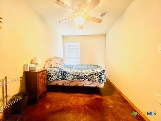 a bed sitting in a bedroom next to a window