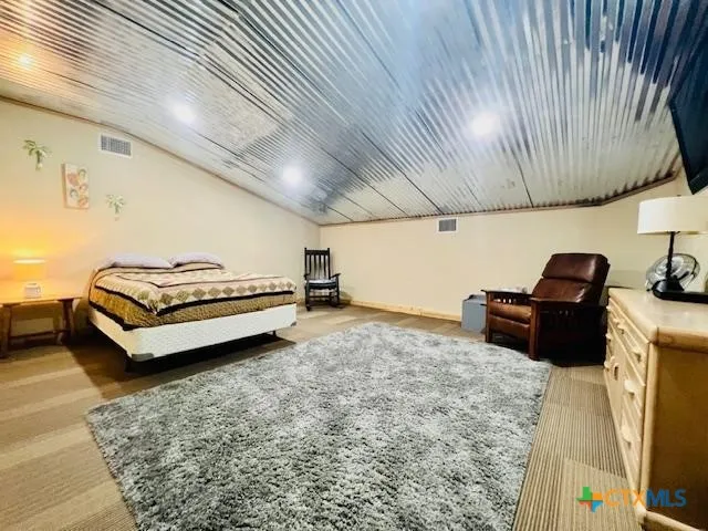 a bedroom with furniture and a flat screen tv