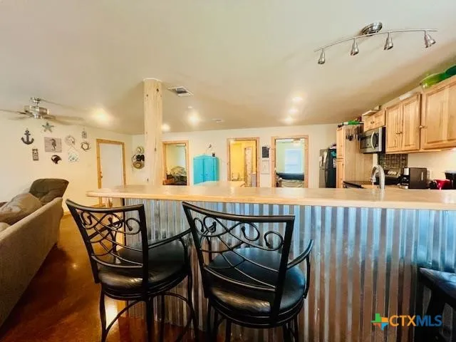 a view of a dining room with furniture and a kitchen