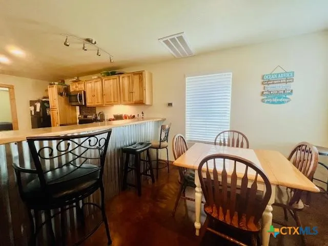 a dining room with a wooden table and chairs