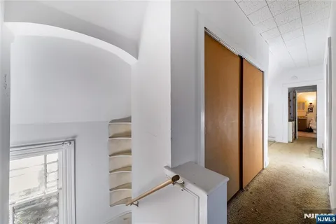 a view of a hallway with bathroom and entryway