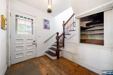 a view of an entryway with wooden floor and windows