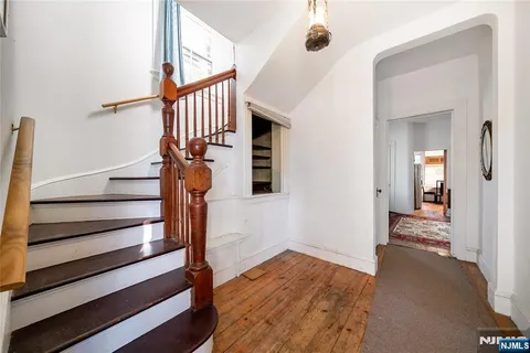 a view of entryway with wooden floor and stairs
