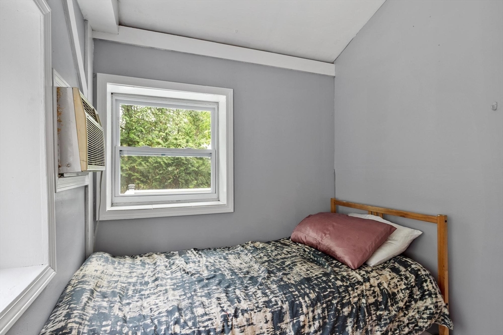144 Bailey Road Holden, MA 01520 - Photo 33 of 42 a wooden bed sitting in a bedroom next to a window