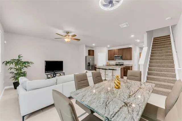 a living room with furniture and kitchen view
