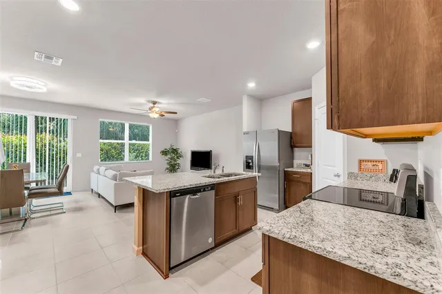 a kitchen with a kitchen island a stove and a refrigerator