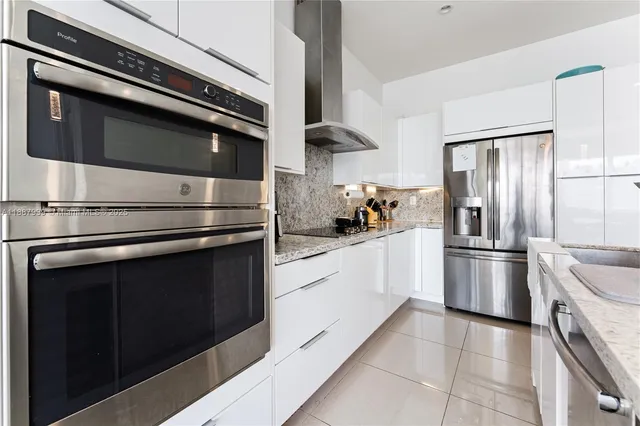 a kitchen with stainless steel appliances and cabinets