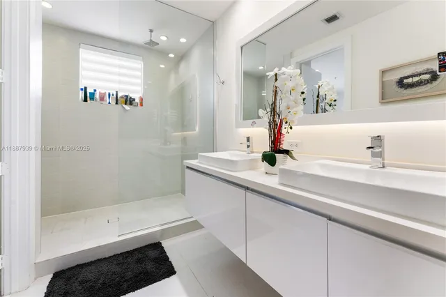 a bathroom with a sink a double vanity and a mirror