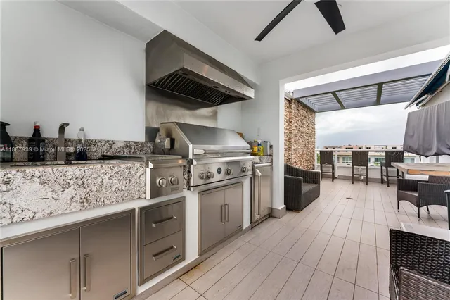 a kitchen with stainless steel appliances granite countertop a stove a sink and a refrigerator