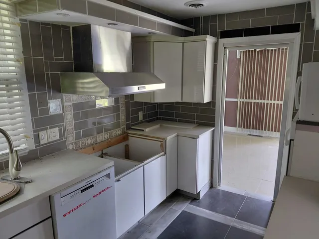 a kitchen with a sink and a refrigerator