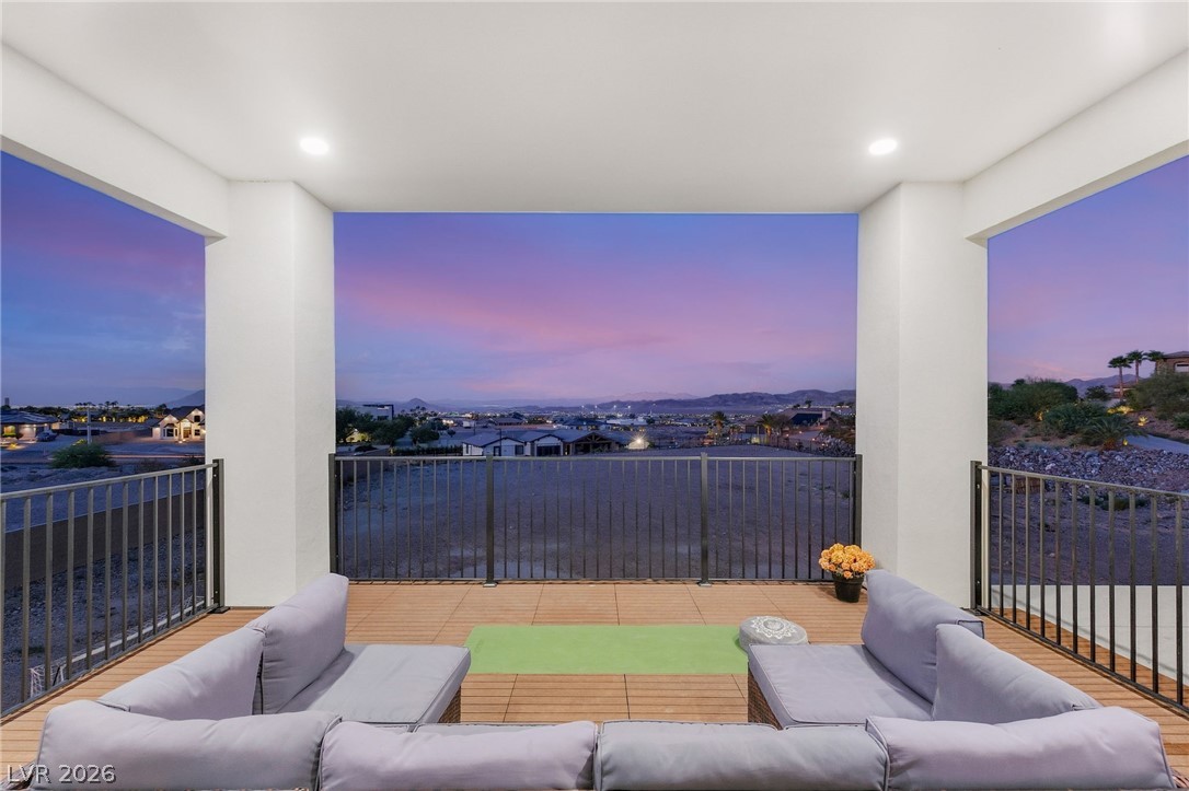 324 Wanda Road Henderson, NV 89002 - Photo 39 of 96 An elevated covered balcony showcases wood plank flooring and expansive horizon views.