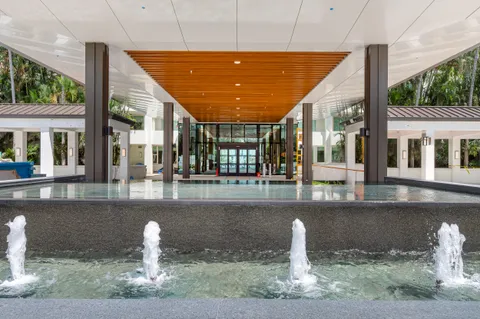 a view of a swimming pool with a lounge chair and a lake view