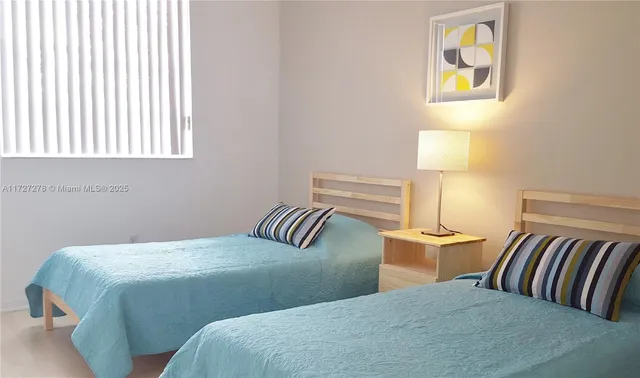 a bedroom with a bed and lamp