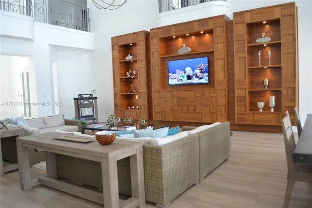 a view of a livingroom with furniture and a window