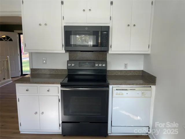 a stove top oven sitting inside of a kitchen