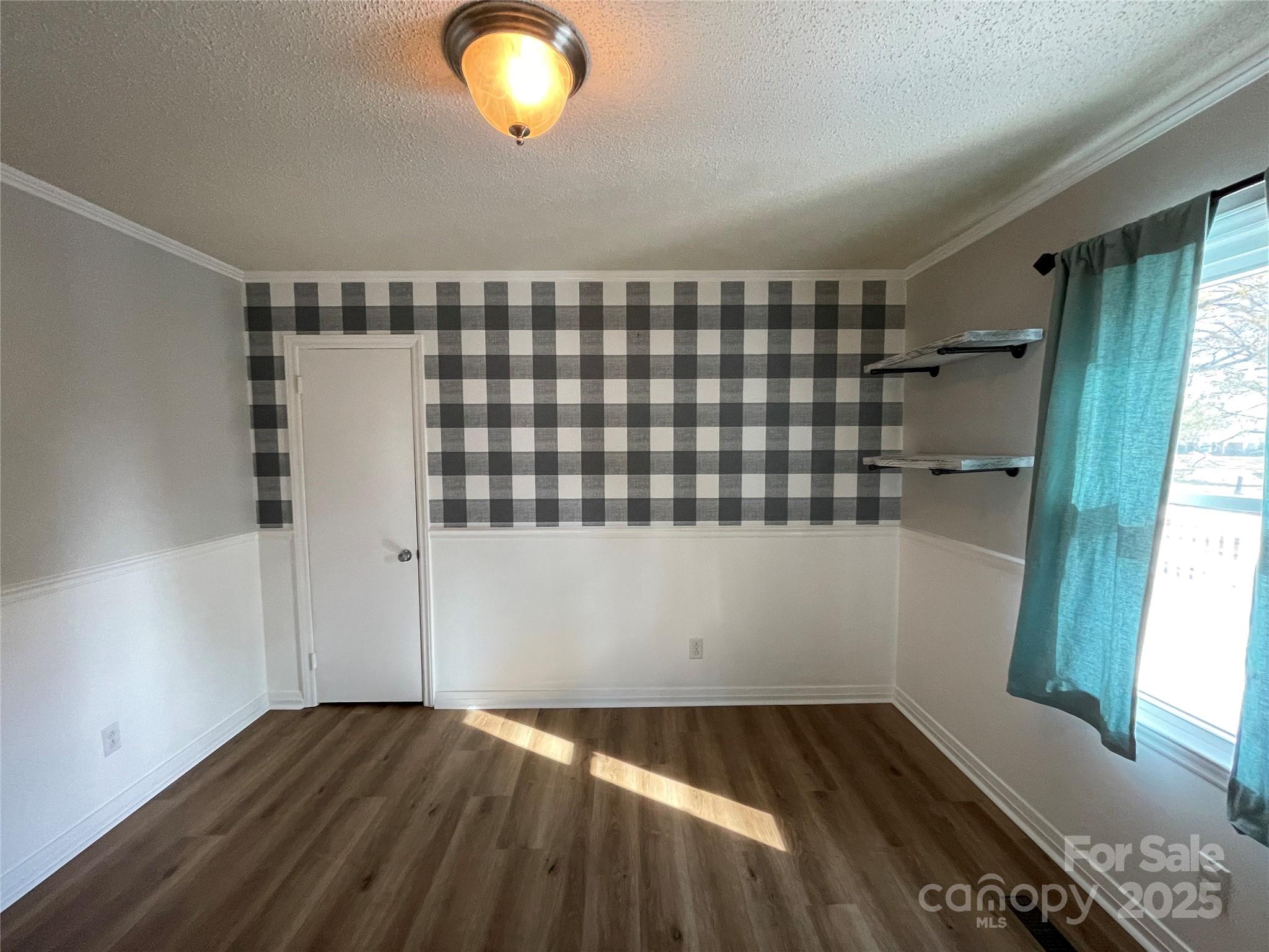 613 Gurley Street Albemarle, NC 28001 - Photo 12 of 43 a view of empty room with wooden floor