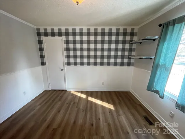 a view of hallway with stairs and wooden floor