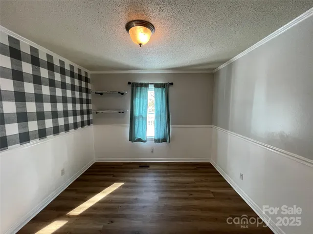 a view of a room with wooden floor and window