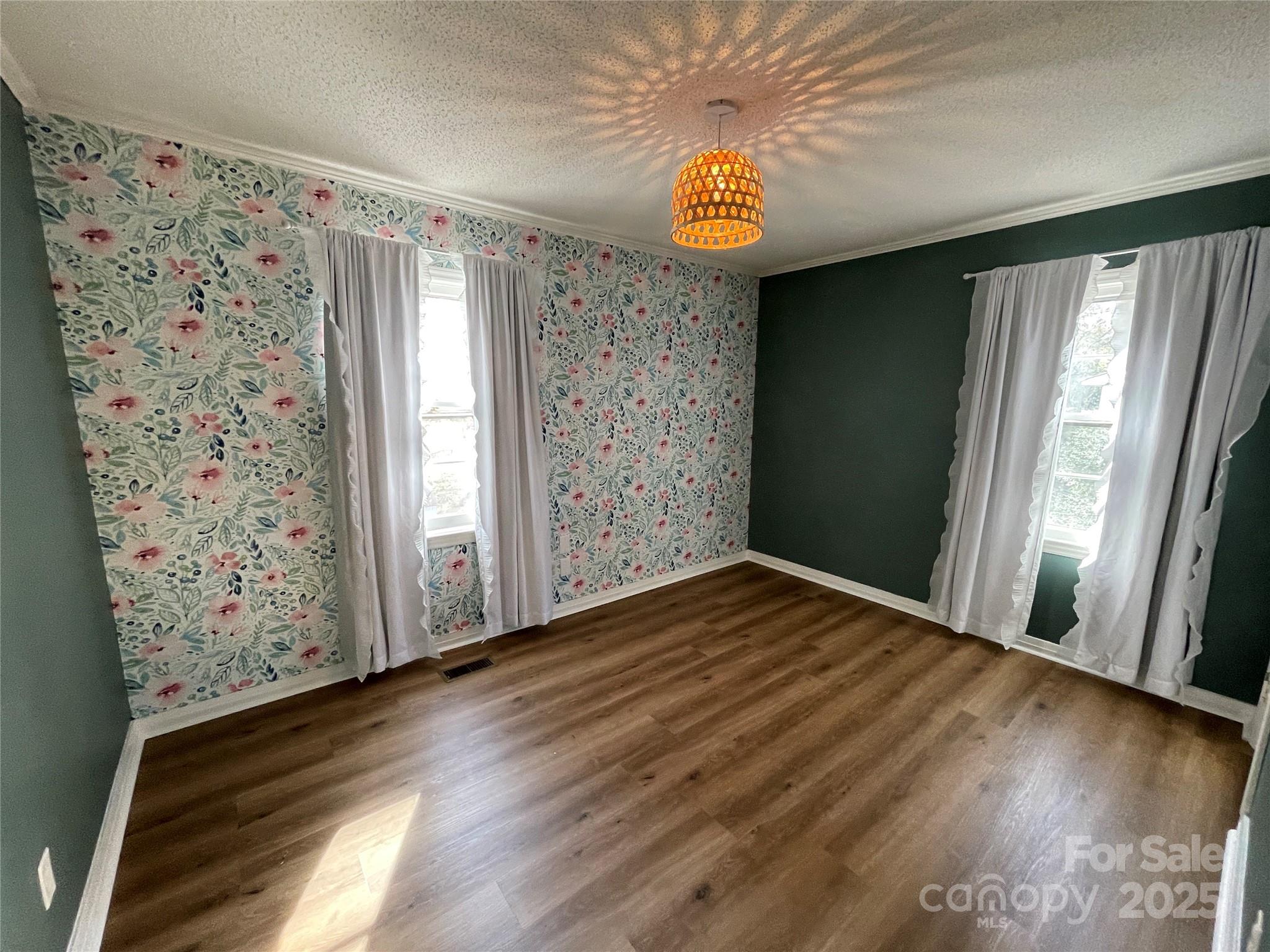 613 Gurley Street Albemarle, NC 28001 - Photo 17 of 43 a view of empty room with wooden floor and fan