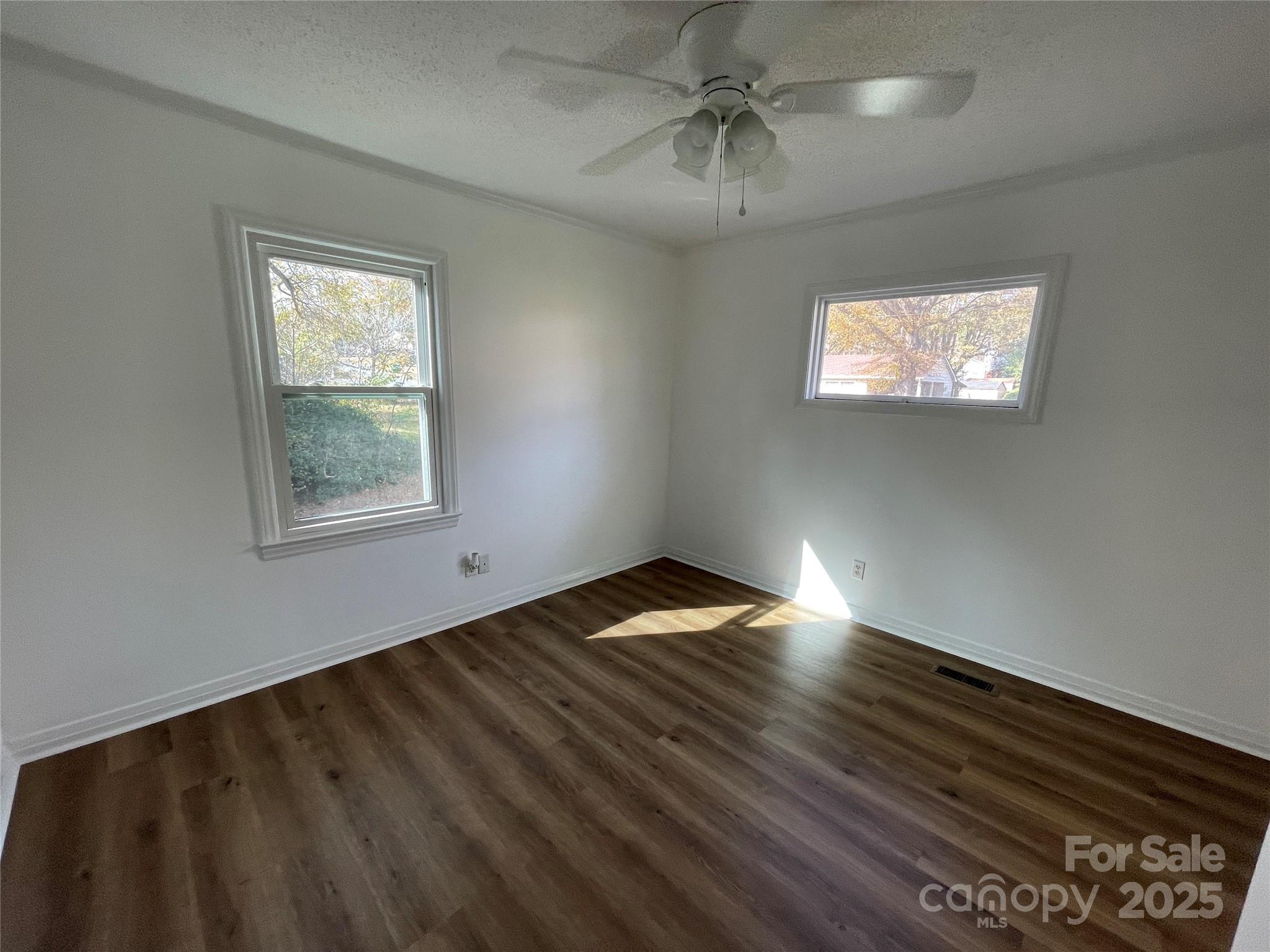 613 Gurley Street Albemarle, NC 28001 - Photo 20 of 43 a view of empty room with wooden floor and fan