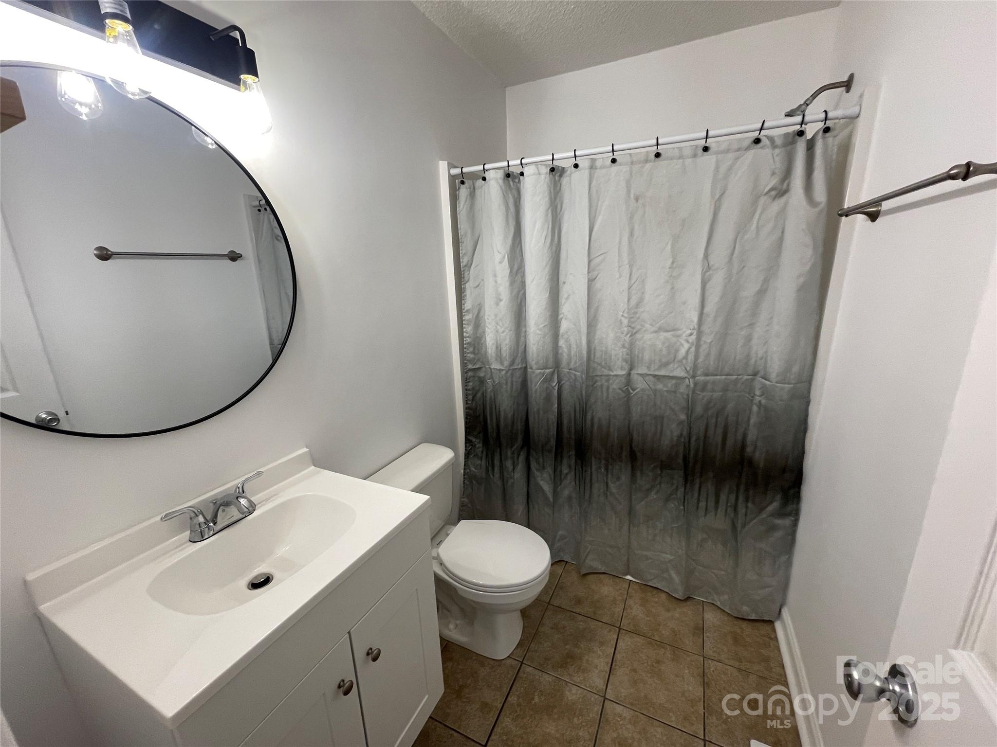 613 Gurley Street Albemarle, NC 28001 - Photo 22 of 43 a bathroom with a sink a toilet and a mirror