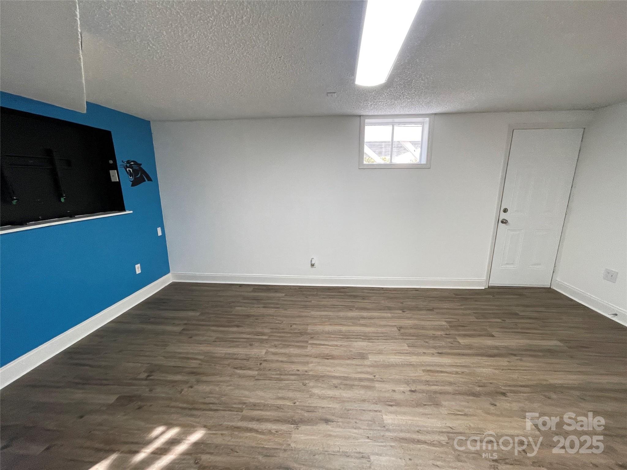 613 Gurley Street Albemarle, NC 28001 - Photo 25 of 43 a view of an empty room with wooden floor and a window