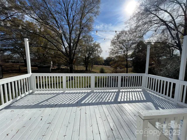 a view of a wooden deck with trees
