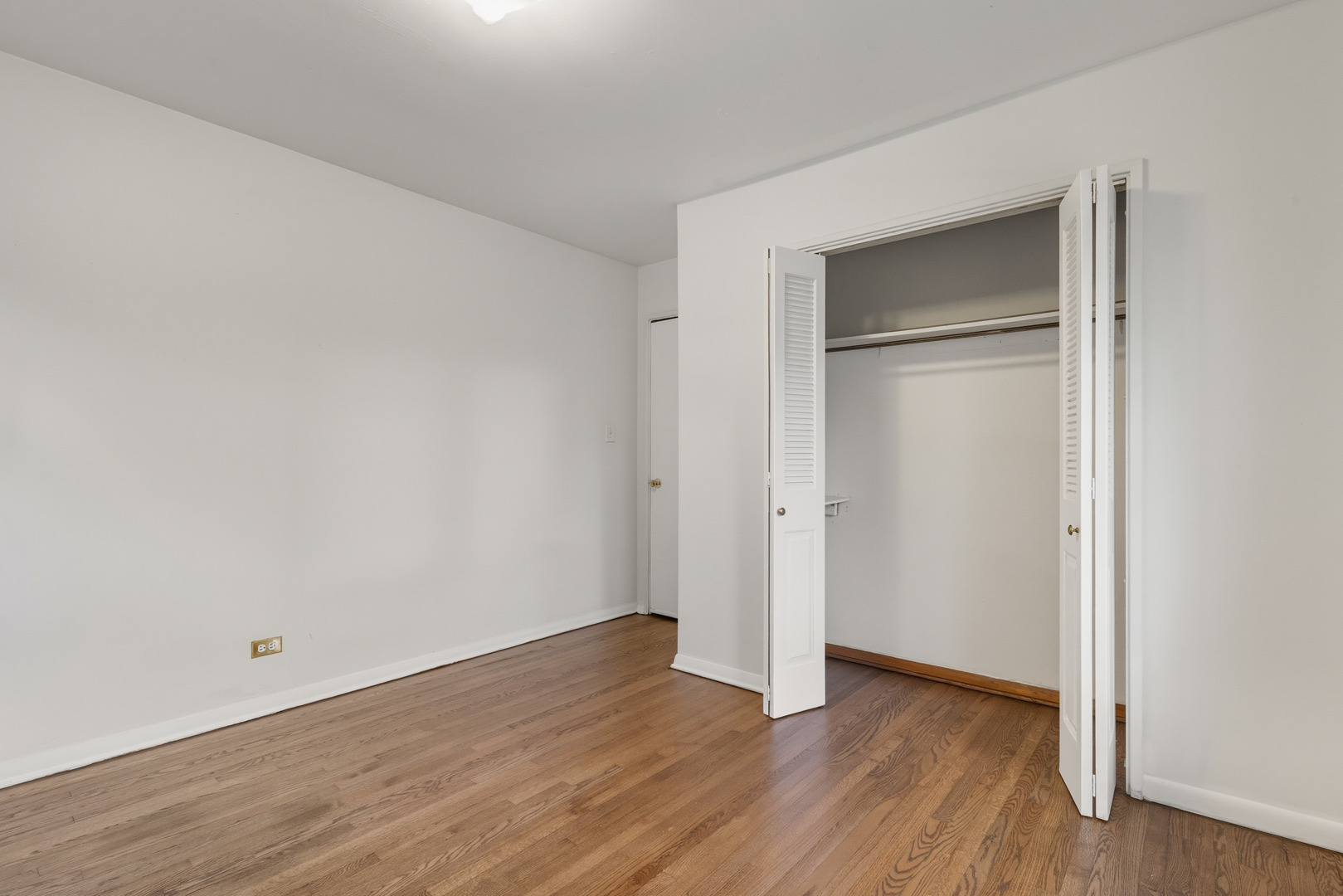 11013 Menard Avenue Chicago Ridge, IL 60415 - Photo 12 of 40 a view of an empty room with wooden floor & closet
