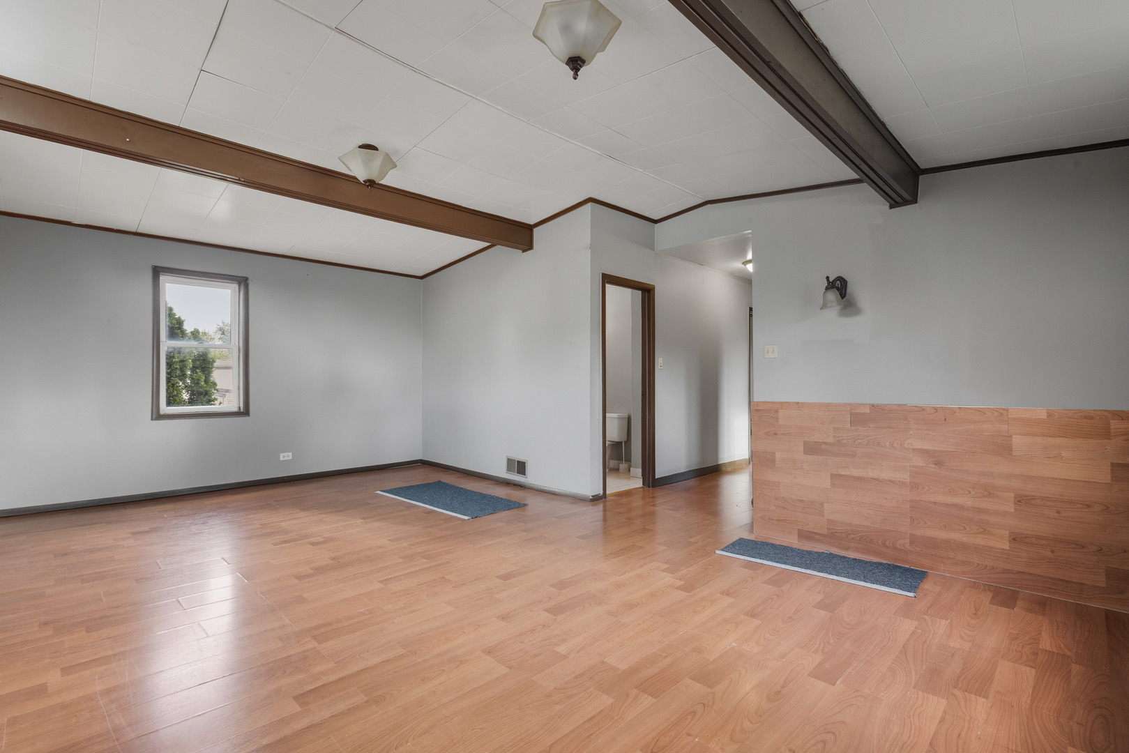 11013 Menard Avenue Chicago Ridge, IL 60415 - Photo 17 of 40 a view of an empty room with wooden floor and a window