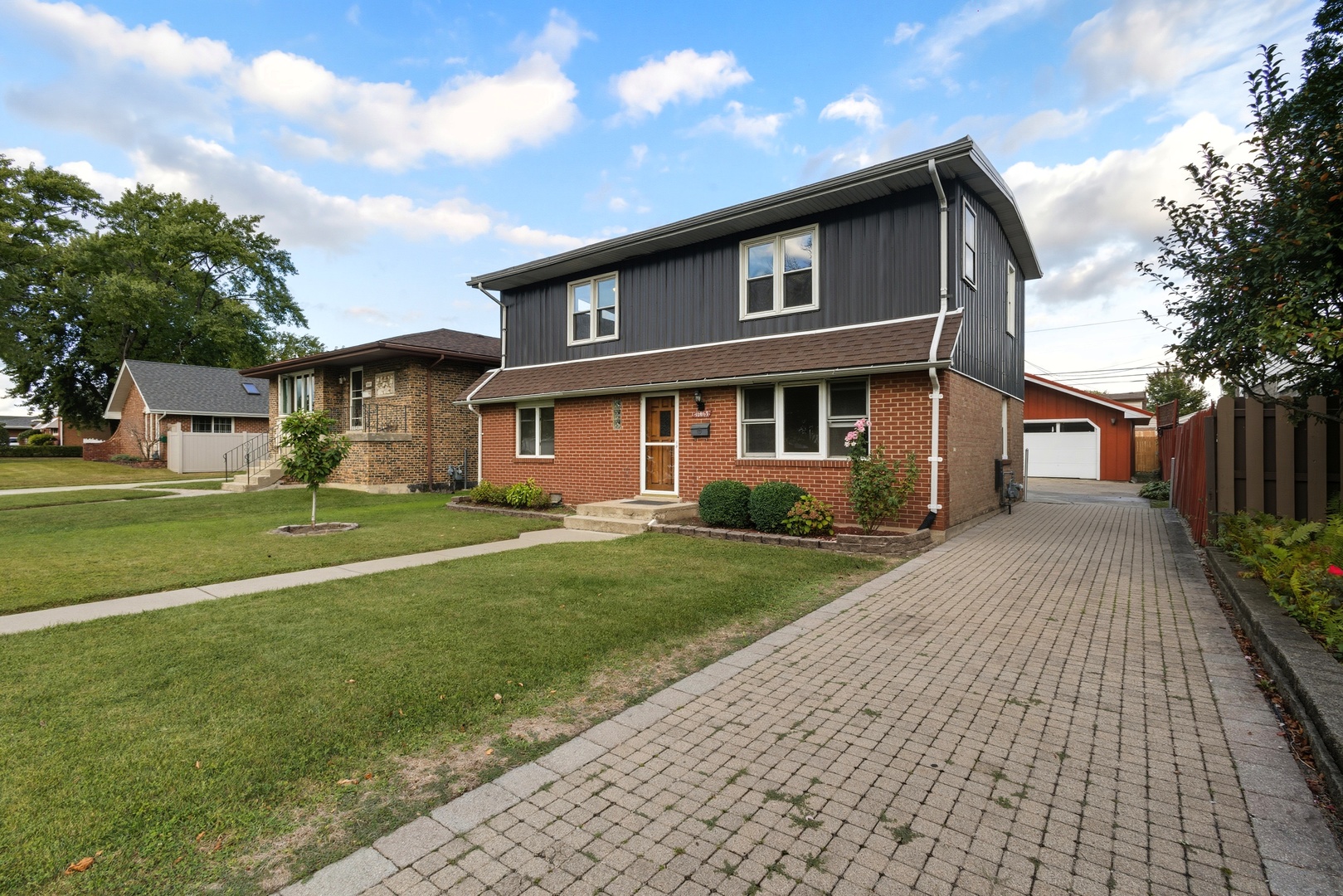 11013 Menard Avenue Chicago Ridge, IL 60415 - Photo 2 of 40 a front view of a house with a yard