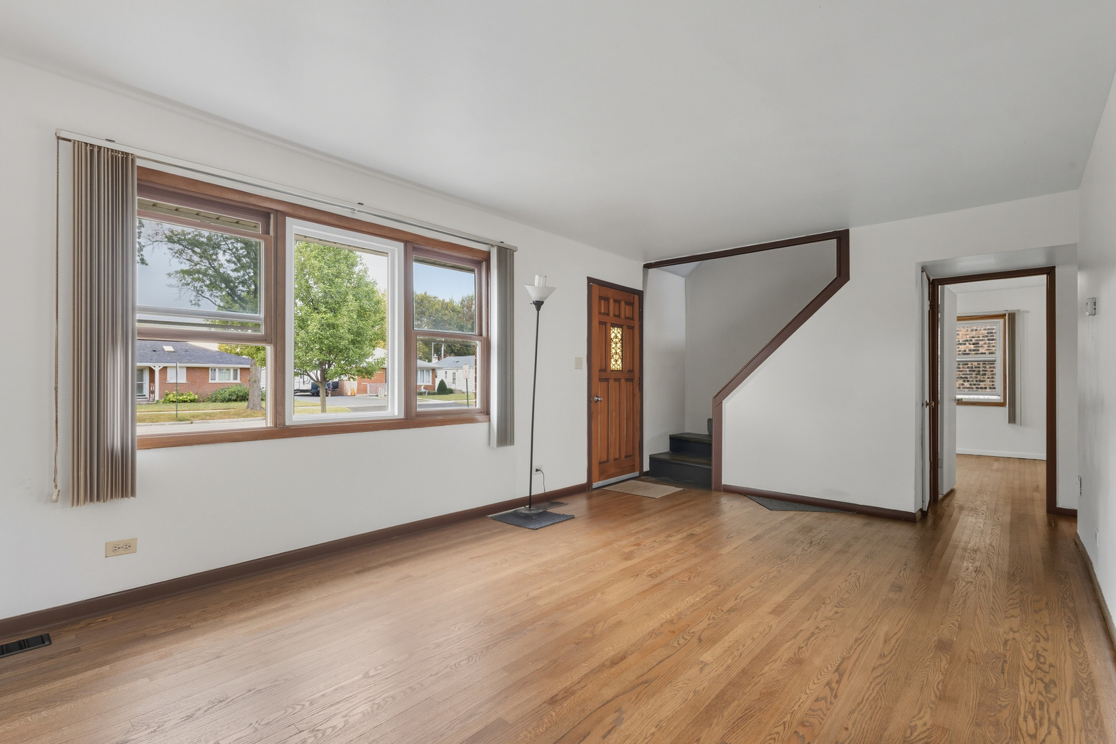 11013 Menard Avenue Chicago Ridge, IL 60415 - Photo 3 of 40 a view of a big room with wooden floor and windows